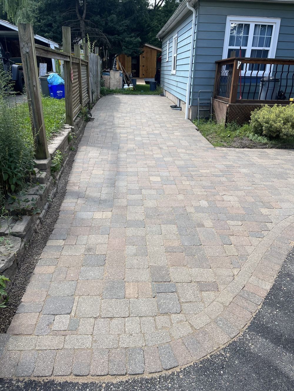 After: finished cobble walkway between the fence and the house, level from the driveway to the back deck